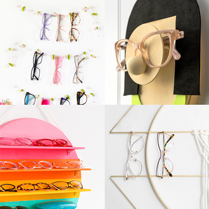 Various eyeglasses displayed on colorful and creatively designed racks and holders.