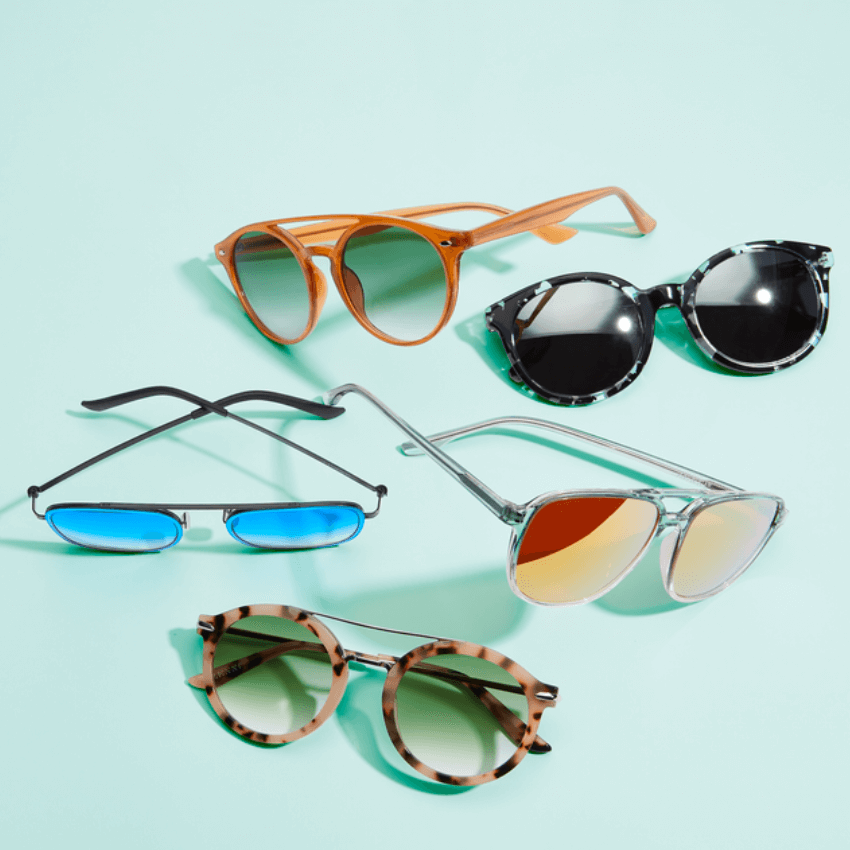 Various styles of sunglasses: tortoiseshell, round, aviator, and reflective blue and orange lenses.