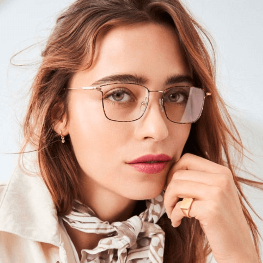 Woman wearing rectangular glasses with thin metallic frames.