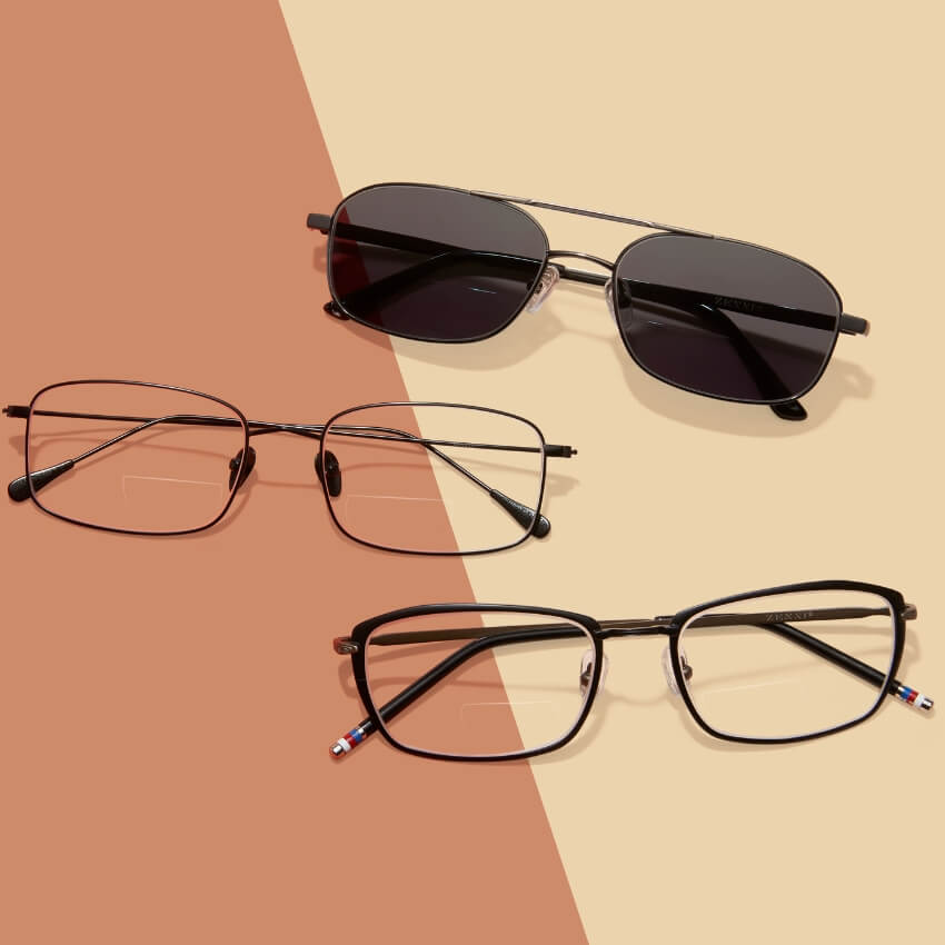 Three pairs of black eyeglass frames, one tinted and two clear.