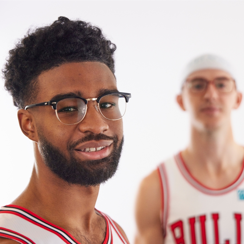 Two men wearing eyeglasses and basketball jerseys, one with a "Bulls" logo.
