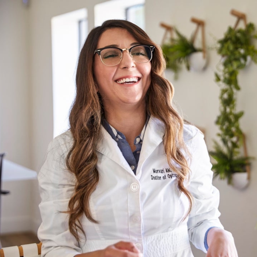 Female optometrist wearing glasses and a white coat with text "Morvarid Ahdipour, Doctor of Optometry."