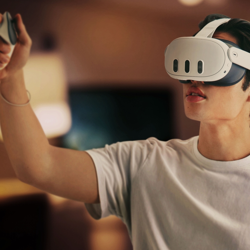 Person wearing a virtual reality headset and holding a controller.