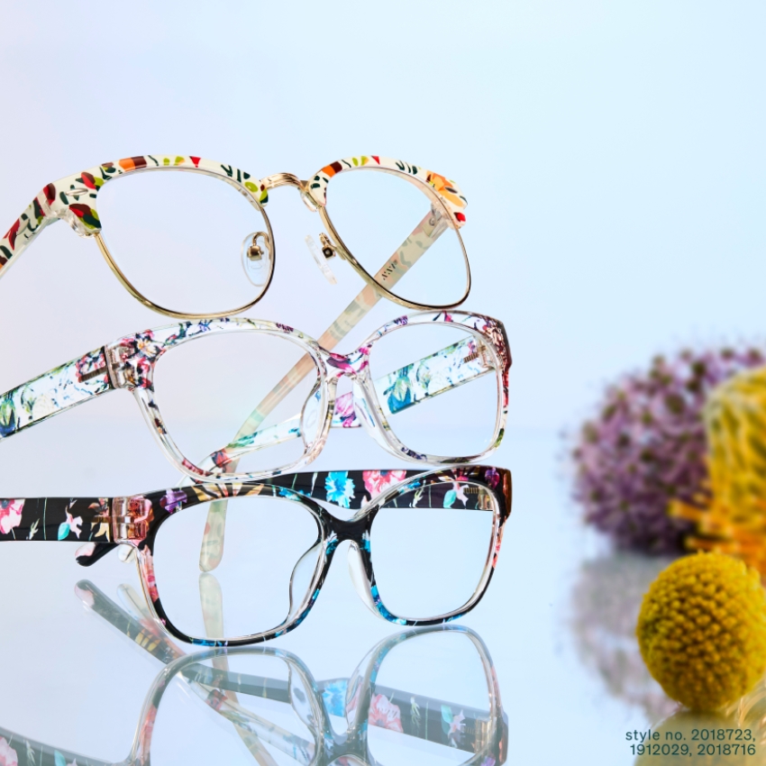 Floral-patterned eyeglasses, style no. 2018723, 1912029, 2018716, on reflective surface.